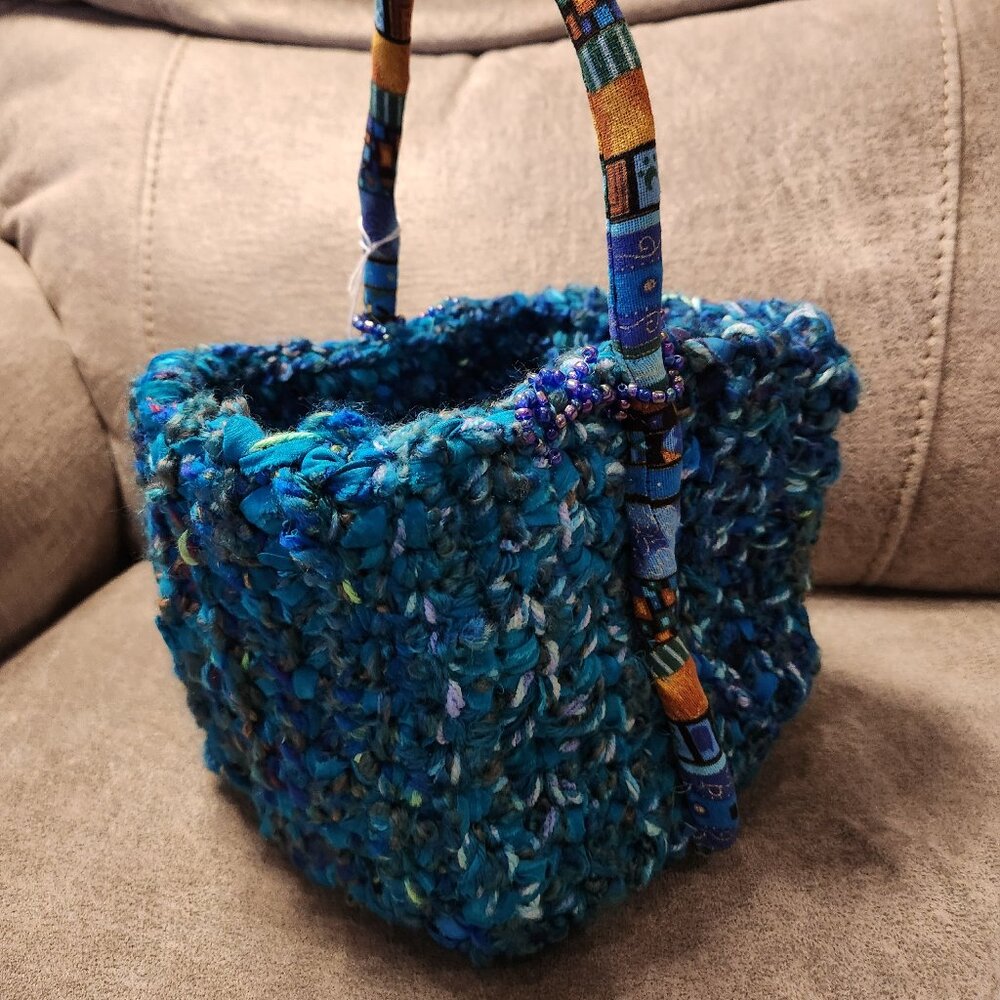 Basket, crocheted, new, 9x7in.with bendable, colorful handle.